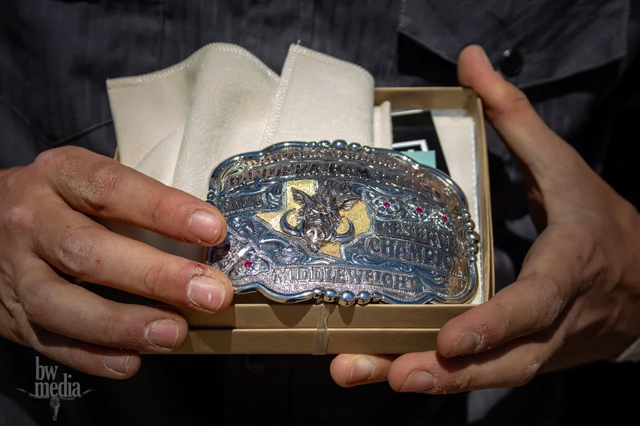 Another Ham Rodeo championship buckle, held up in its box.