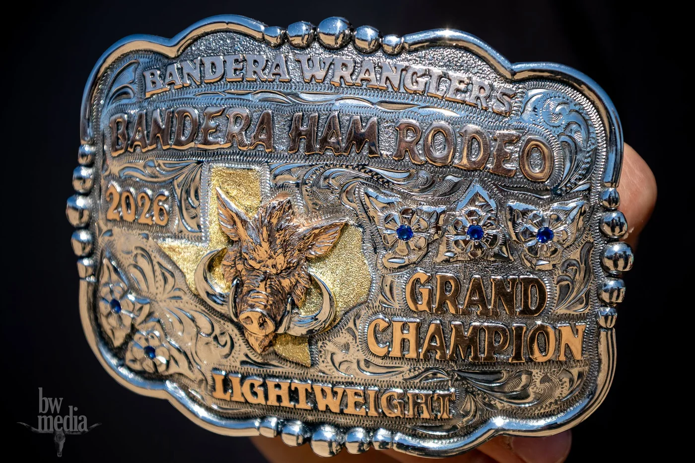 Engraved Bandera Wranglers Bandera Ham Rodeo 2026 Grand Champion lightweight belt buckle.