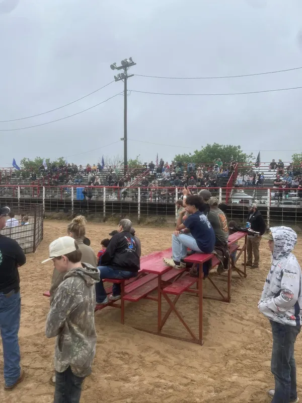 A full crowd in the red bleachers watching the Ham Rodeo.